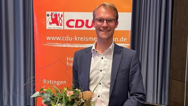 Dr. Christian Untrieser mit Blumenstrauß vor CDU Banner