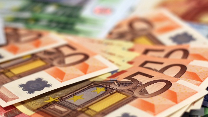 50-Euro-Scheine, im Hintergrund unscharf: 100-Euro-Scheine